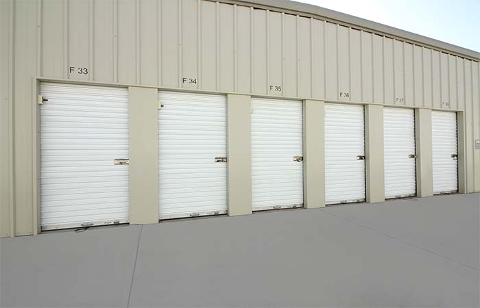 Small drive-up storage units with roll-up doors.