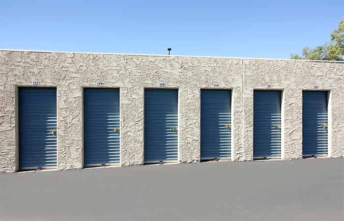 Small drive-up storage units with easy access and roll-up doors.
