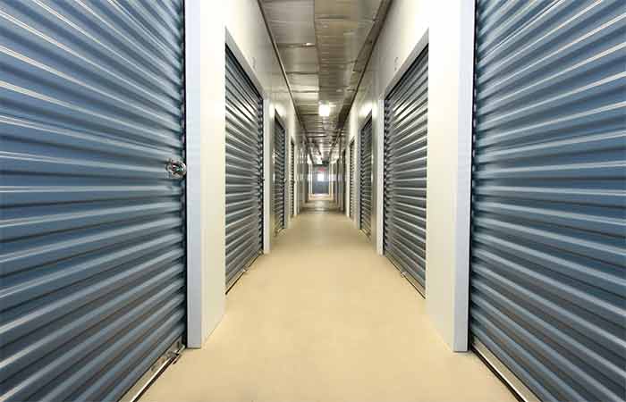Indoor climate controlled storage units in well-lit hallways for easy access.