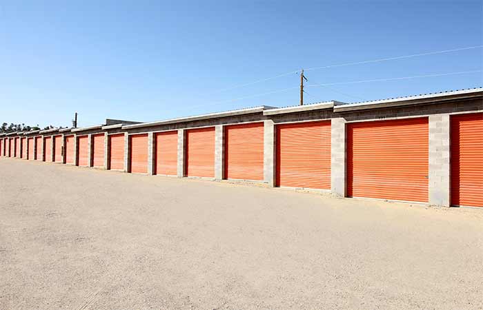 Drive-up storage units with easy access and roll-up doors.