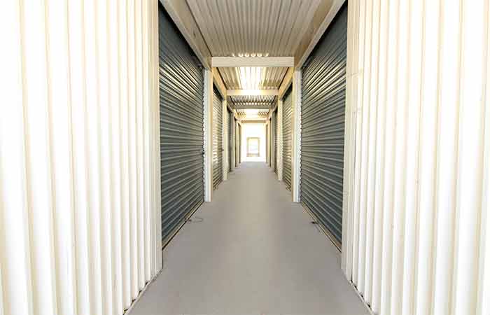 Breezeway storage unit hallway with roll-up doors.