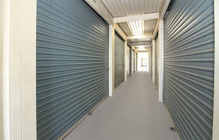 Large breezeway storage units in a well-lit hallway.