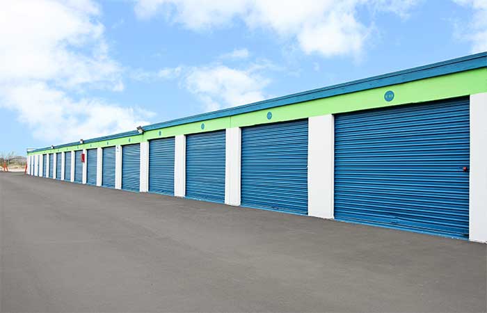 Large drive-up storage units with roll-up doors for easy access.