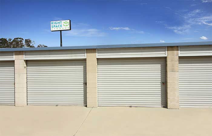 Large drive-up storage units with roll-up doors.