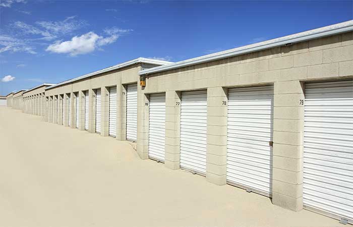 Small drive-up storage units in a wide aisle for easy access.