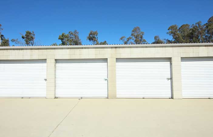 Drive-up storage units with roll-up doors.