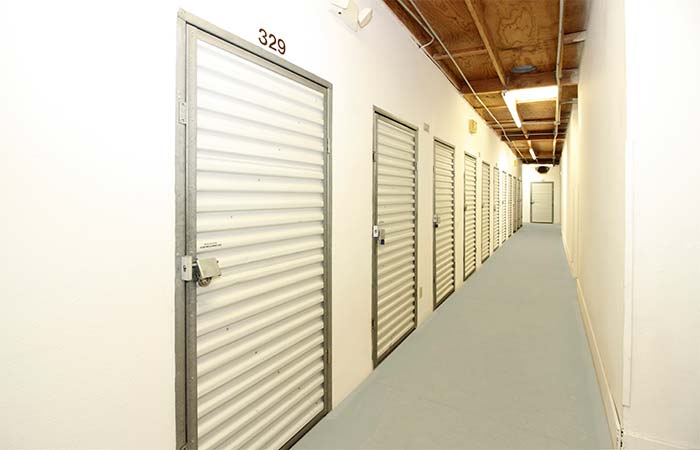 Small indoor storage units with swing doors.