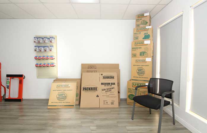 Moving and storage supplies for sale including boxes and tape.