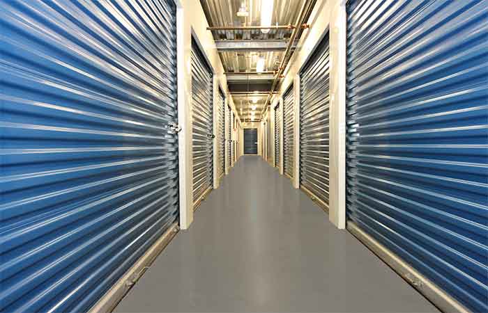 Large indoor storage units with roll-up doors for ease of access.