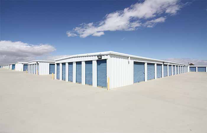 Drive-up storage units with wide aisles and roll-up doors for easy access.