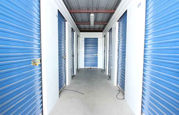 Small indoor storage units with roll-up doors.