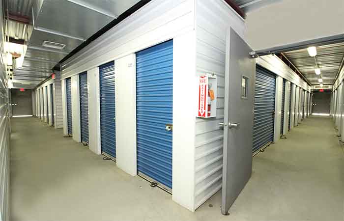 Indoor storage units located in well-lit hallways.
