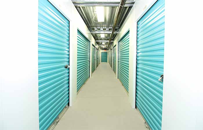 Indoor storage units in a well-lit hallway.
