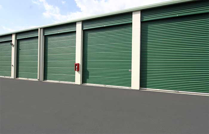 Tall drive-up storage units for with easy access and roll-up doors.
