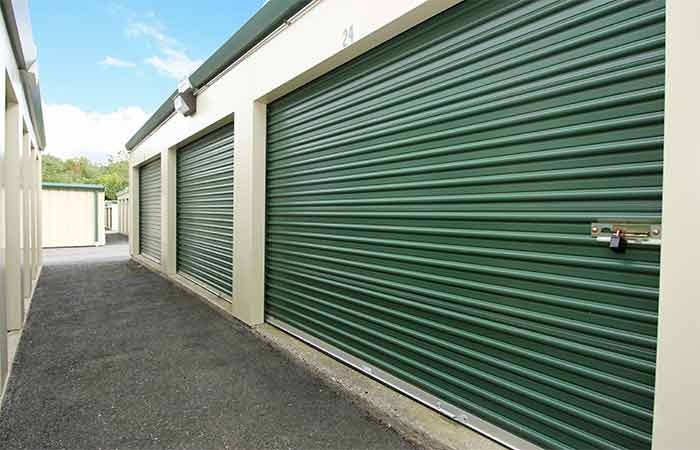 Large breezeway storage units with roll-up doors.