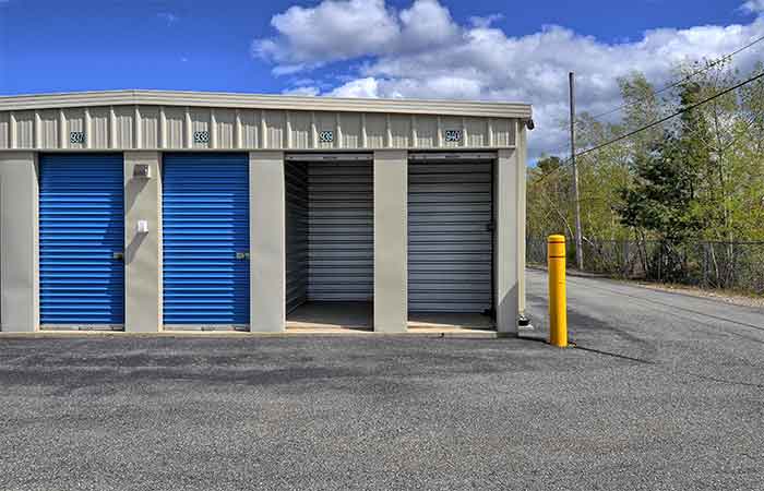 Small drive-up storage unit with roll-up doors for easy access.