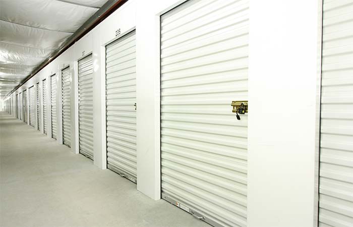 Small indoor climate controlled storage units with roll-up doors.