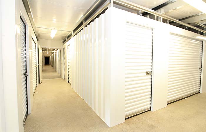 Indoor climate controlled storage units in well-lit hallways.