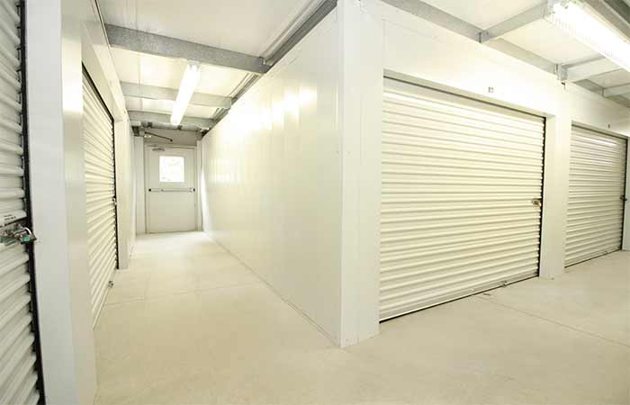 Indoor storage units in a well-lit hallway with easy access.