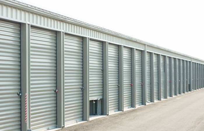 Small drive-up storage units with roll-up doors for easy access.