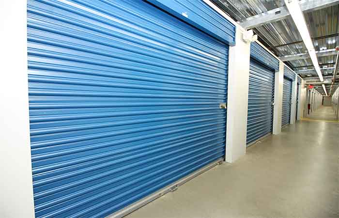 Large indoor climate controlled storage units with roll-up doors.