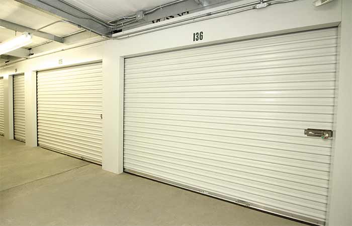 Large indoor storage units in a well-lit hallway.