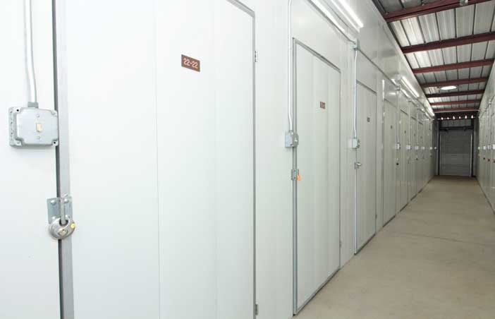 Small indoor storage units in a well-lit hallway.