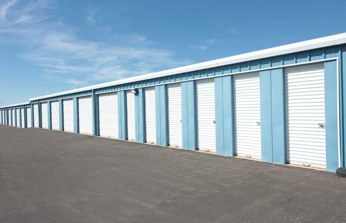 Drive-up storage unit row with both large and small units.