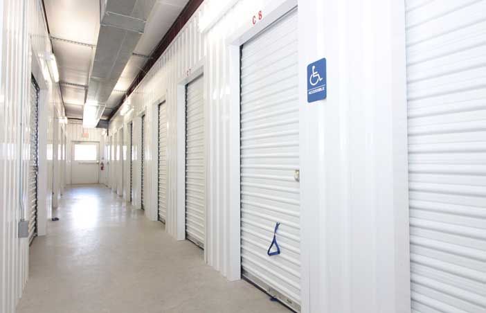 Accessible climate-controlled units in a well-lit hallway.
