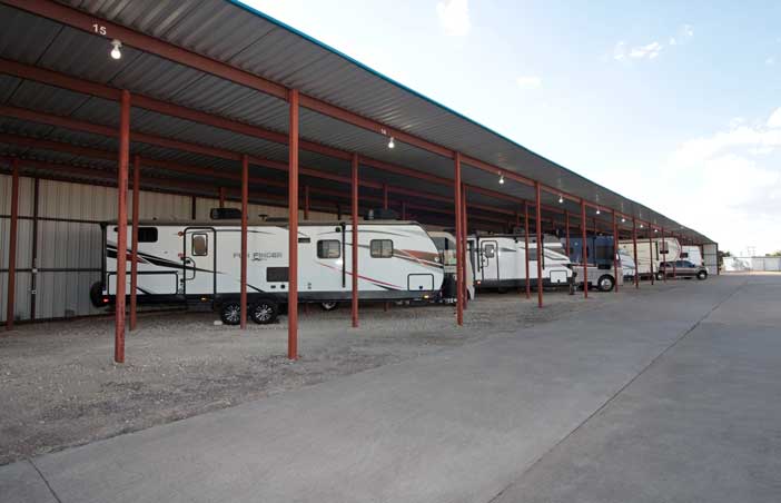 Covered, unpaved RV parking.
