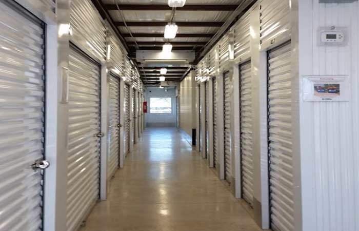 Indoor storage units in a well-lit hallway.