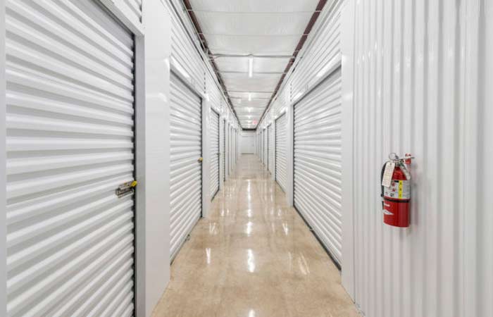 Indoor climate controlled storage units in a well-lit hallway.