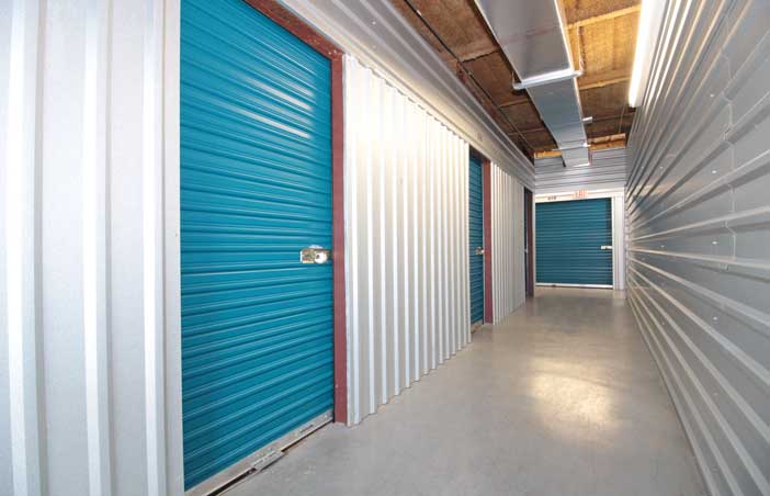 Small climate controlled storage units in a well-lit hallway.