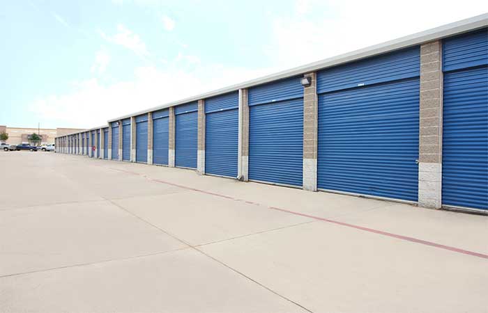 Tall drive-up storage units with roll-up doors.