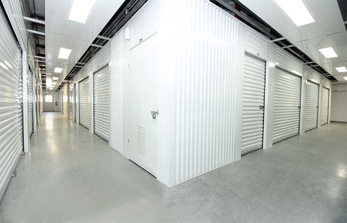 Indoor climate controlled storage units in well-lit hallway.