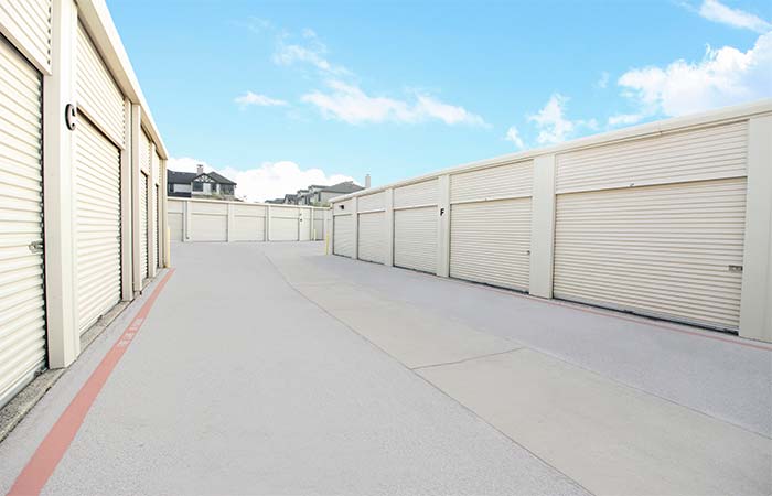 Large drive-up storage units with easy access in a wide aisle.