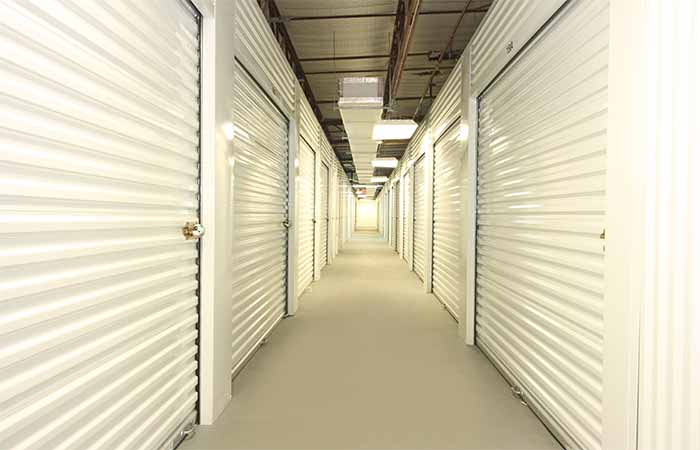 Indoor climate controlled storage units in a well-lit hallway.